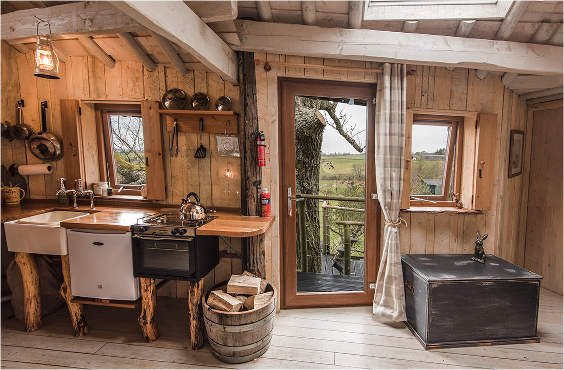 Interior of romantic getaway treehouse glamping site
