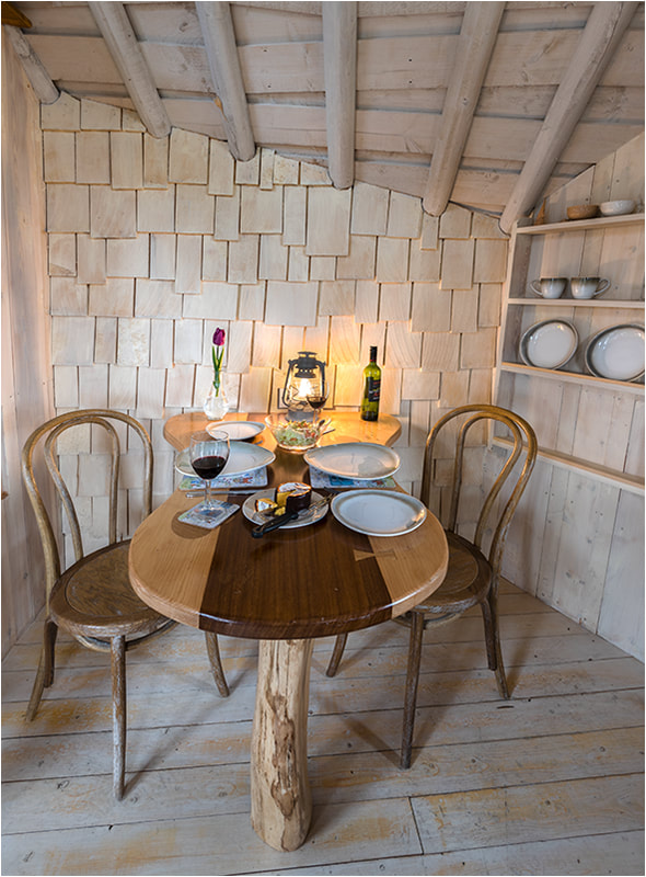 Dining table for romantic getaway treehouse glamping site
